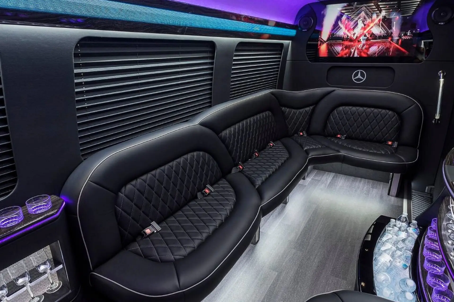 Luxury Mercedes Sprinter party bus interior — LED mood lighting, premium leather seating, and sound system for Aurora events